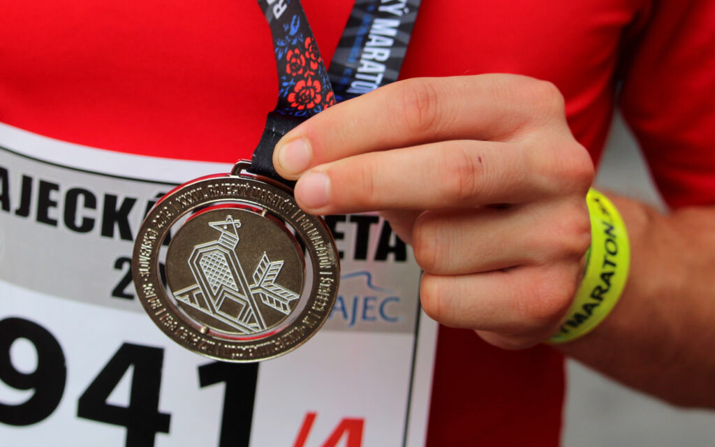 Eine Großaufnahme von einem jungen Mann, der eine Medaille in der Hand hält